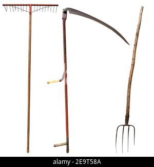 Scythe, Pitchfork and a Rake. Vintage gardening equipment isolated on white background. Italy, photography. Stock Photo