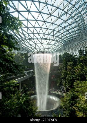 The sun reflects off the waterfall in the heart of the changi singapore airport jewel terminal 4 Stock Photo