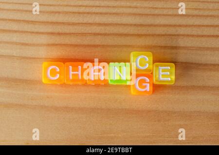 CHANGE CHANCE text with color letters cubes on wooden background. Minimal business concept. Stock Photo