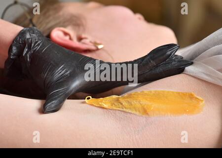 Waxing of female armpits. Close-up Beauty and body care concept. Stock Photo