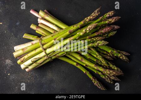 View of fresh asparagus on a black table. Food background. Stock Photo