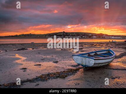 Appledore, North Devon, England. Saturday 6th February 2021. UK Weather. After a week of grey skies in North Devon, the clouds break as the sun rises over the River Torridge estuary at low tide in the picturesque coastal villages of Appledore and Instow. Credit: Terry Mathews/Alamy Live News Stock Photo