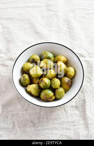 Roasted brussles sprouts in bowl over light background. Close up view Stock Photo