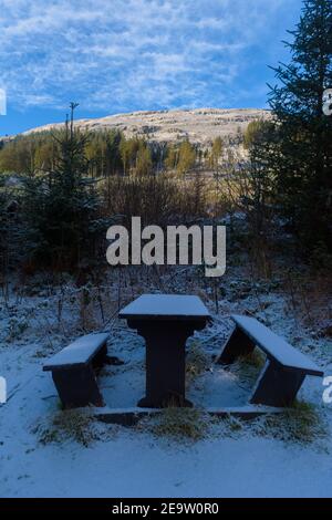 Snow Covered Picnic Benches on a Mountain Walk in Scotland Stock Photo