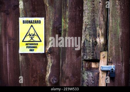 Chemical factory biohazard sign danger warning at entrance gate Stock Photo