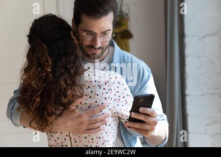 Unfair husband simulate love with wife while reading mistress messages Stock Photo