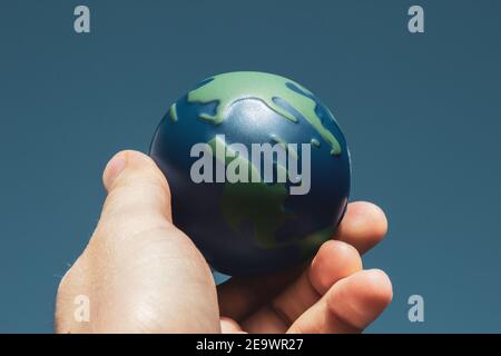 Earth Day. Male hand holding earth in his hands. Human saving planet earth. There is no planet b concept. Earth day concept. Protecting the world is i Stock Photo