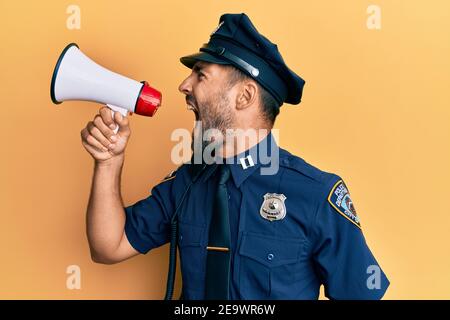 American police officer shouting through megaphone, yelling and protesting Stock Photo