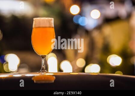 A glass of delicious craft beer served on an authentic beer glass, to be used as a background. Stock Photo