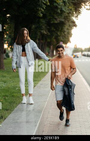 Cheerful couple enjoying walking in the city. Casual style people. Couple in love in the city. Urban lovestory Stock Photo