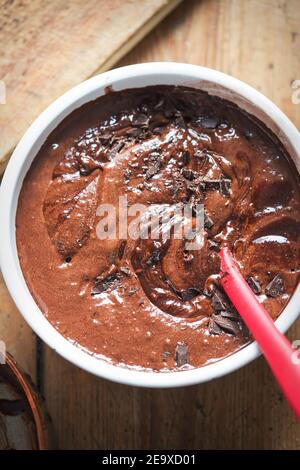 Making chocolate chilli brownies. Mixing batter with spatula Stock Photo