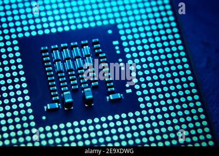 Tech innovation concept background. Close-up of CPU Chip Computer Processor in the lab with blue dramatic toned. Selective Focus. Stock Photo