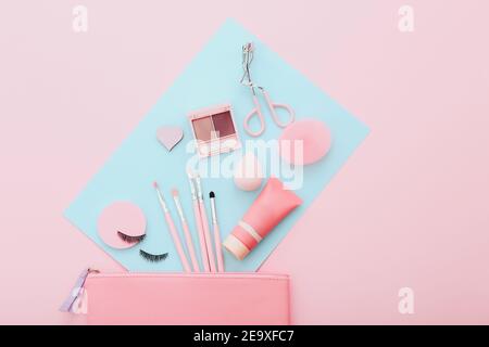 Makeup tools and accessories on blue and pink background. Beauty concept. Flat lay composition, top view Stock Photo