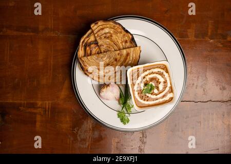 Dal makhani or daal makhni is a popular food from Punjab / India made with garlic naan or Indian bread or roti. Stock Photo