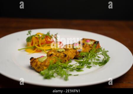 Chicken skew Kebab.Traditional Indian dish cooked on charcoal and flame. Stock Photo