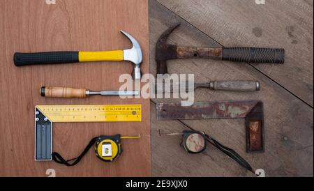Hamer chisel Tape measure Ruler Collection of old and new woodworking handtools on a rough workbench wooden Stock Photo