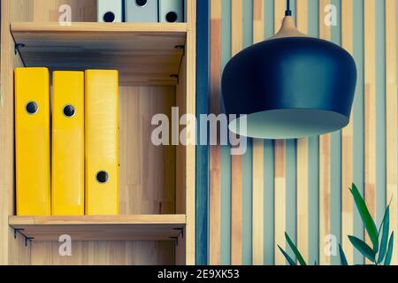 File folders, standing on the shelves at office. minimalist design concept Stock Photo