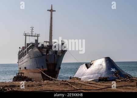 Ship being broken up at Gadani ship-breaking yard, located across a 10 km long beachfront, Balochistan, Pakistan. Stock Photo