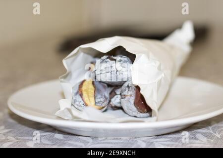 Roasted chestnuts on white plate Stock Photo