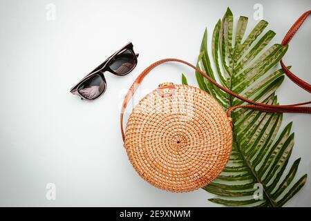 Eco friendly wicker Straw bag over blue background with space for text, top view, wide composition. Summer vacation fashion, holiday concept. Stock Photo