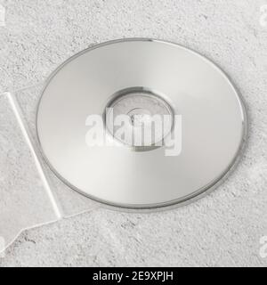 Realistic white cd template with box cover on white cement background. Stock Photo