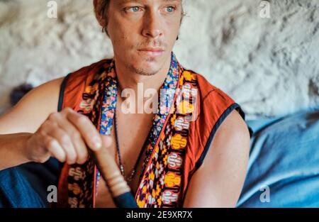 Blond man practicing meditation at home Stock Photo