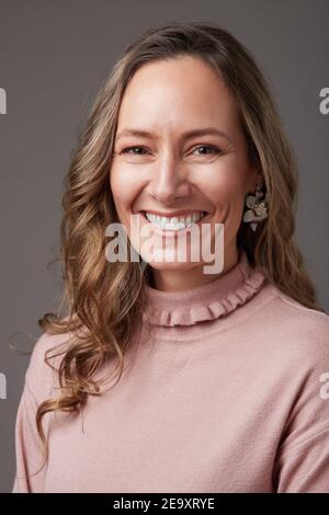 Portrait of happy elegant mature businessWoman standing studio looking at camera Stock Photo