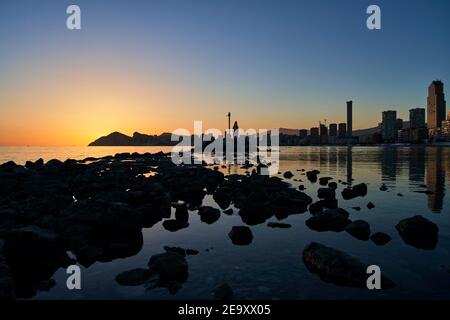 Sunset on Benidorm Poniente Beach, close to Levante. View on Hotel Bali, InTempo and skyline Stock Photo