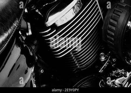 Powerful motorcycle engine block with chrome details and reflective surfaces, black and white close-up. Stock Photo