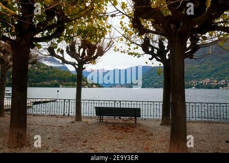 Empty bench on waterfront of Cernobbio Village on Como Lake, Italy in november Stock Photo