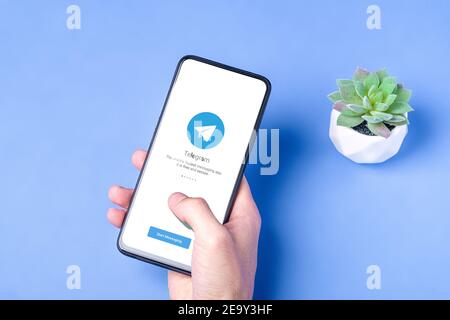 Melitopol, Ukraine - January 18 2021: Telegram application icon on smartphone screen. Online secure social media network. Blue background Stock Photo