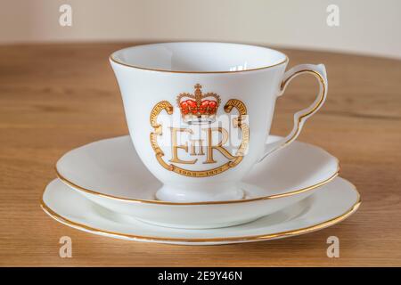 Vintage bone china tableware special edition Royal Silver Jubilee, cup and saucer on plate with the Royal cypher EIIR 1977 - Queen Elizabeth ii, UK Stock Photo