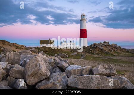 Portland Bill, Dorset, UK.  6th February 2021.  UK Weather.  The sky glows orange above the lighthouse at Portland Bill in Dorset at the end of a day of sunny spells during the Covid-19 lockdown.  Picture Credit: Graham Hunt/Alamy Live News Stock Photo