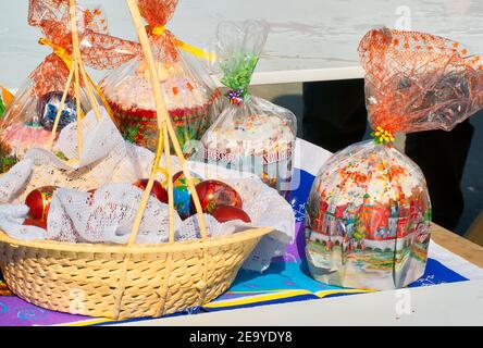 Easter eggs and cakes on lighting near the temple. Stock Photo