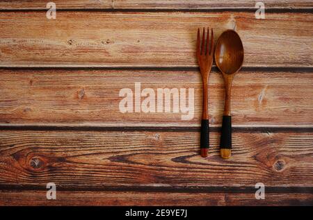 Fork and spoon on a vintage wooden table. Stock Photo