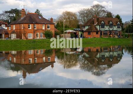 Cookham, Berkshire, UK. 6th February, 2021. Flooding outside properties and the Crown pub on Cookham Moor. A Flood Alert remains in force along the stretch of the River Thames from Hurley to Cookham. The Pound across Cookham Moor flooded earlier this week and remains closed to traffic following flooding. The flood water levels have lessened, however, further rain is expected overnight together with possible snow and the Environment Agency are closely monitoring the situation. Credit: Maureen McLean/Alamy Live News Stock Photo