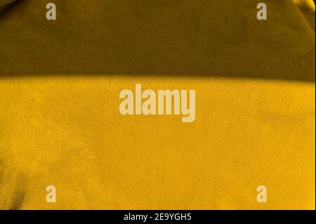 Velvet texture of seamless leather. Felt Yellow material macro. Yellow suede texture. leather Stock Photo