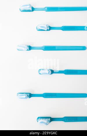 Plastic blue toothbrushes with toothpaste isolated on a white background Stock Photo