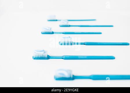 Plastic blue toothbrushes with toothpaste isolated on a white background Stock Photo
