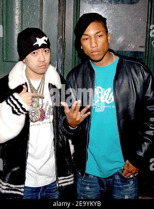 Composer Pharrell Williams and famed Japanese DJ/musician and designer Nigo pose to photographers at the opening of Mr. Nigo's new store 'A Bathing Ape' at Soho, New York City on Tuesday, January 11, 2005. Photo by Slaven Vlasic/ABACA. Stock Photo