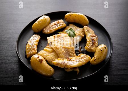 Flounder meuniere style with fried banana Stock Photo