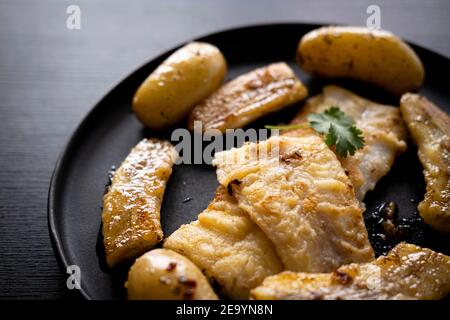 Flounder meuniere style with fried banana Stock Photo