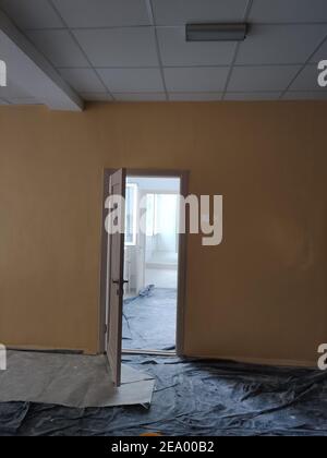 a covered with foil floor during renovation in a long corridor room Stock Photo