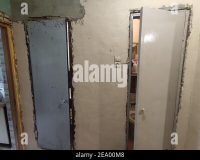 a repair of walls and doors and putty with plaster in the apartment Stock Photo
