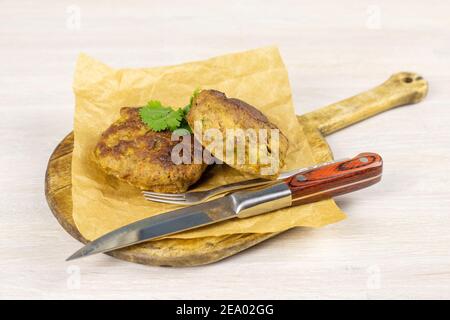 Homemade meat beef burger patties cutlet on cutting board on white table background. Low carb diet Stock Photo