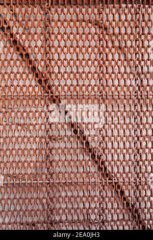 Close-up of rusty metal chains hanging against the wall. Stock Photo