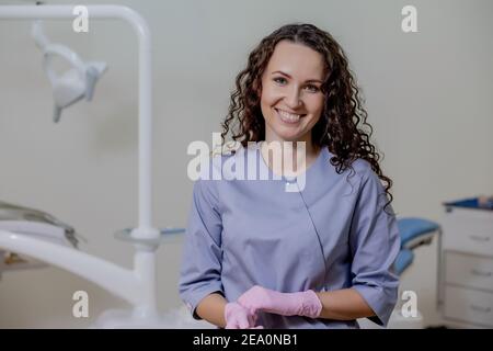 Portrait of female dentist .She standing in her dentist office Stock Photo