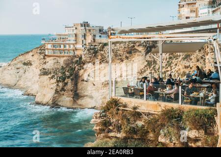 Diners at the Bay Rock Cafe atop a cliff edge near the Raouche Rocks in Beirut, Lebanon Stock Photo