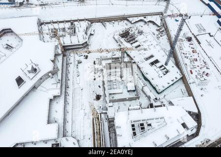 construction of modern high-rise buildings in wintertime. aerial view from flying drone Stock Photo