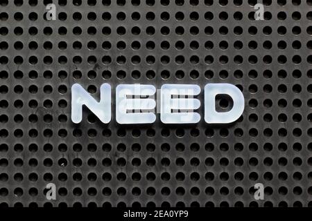 White color letter in word need on black pegboard background Stock Photo